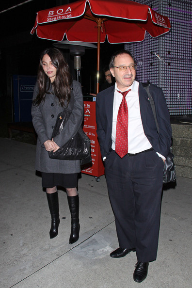 Photo of grigorieva and horowitz. There is an umbrella behind them as they stand waiting for a car outside the Boa steakhouse in los angeles and link to People Magazine article on settlement of five million dollars